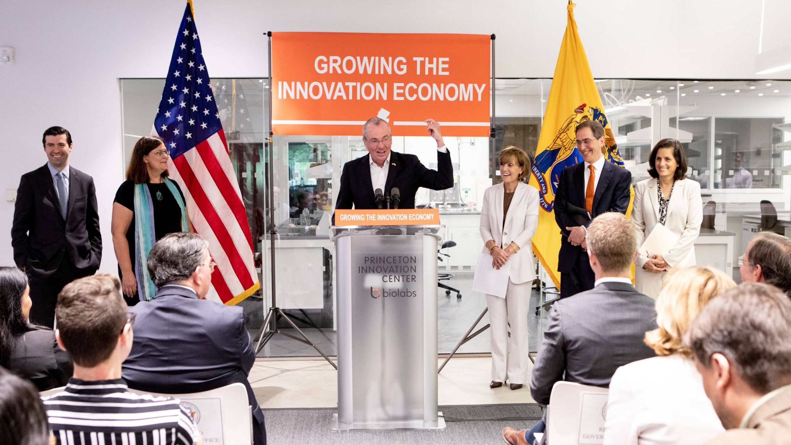 N.J. Gov. Phil Murphy speaks at podium before sign reading "Growing the Innovation Economy."