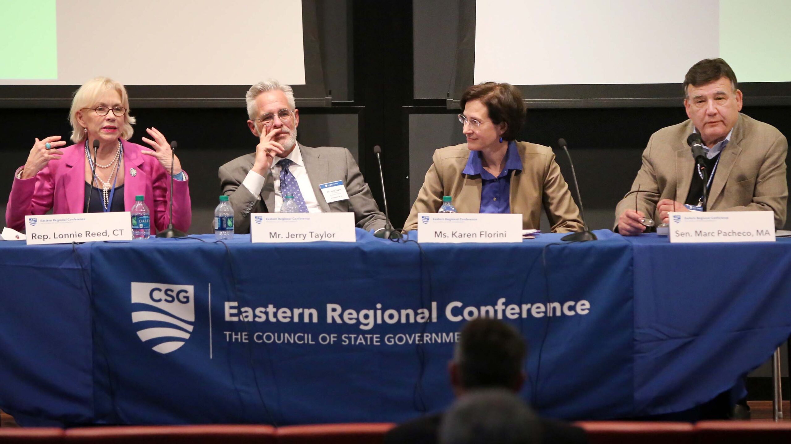 Four panelists speak at a conference