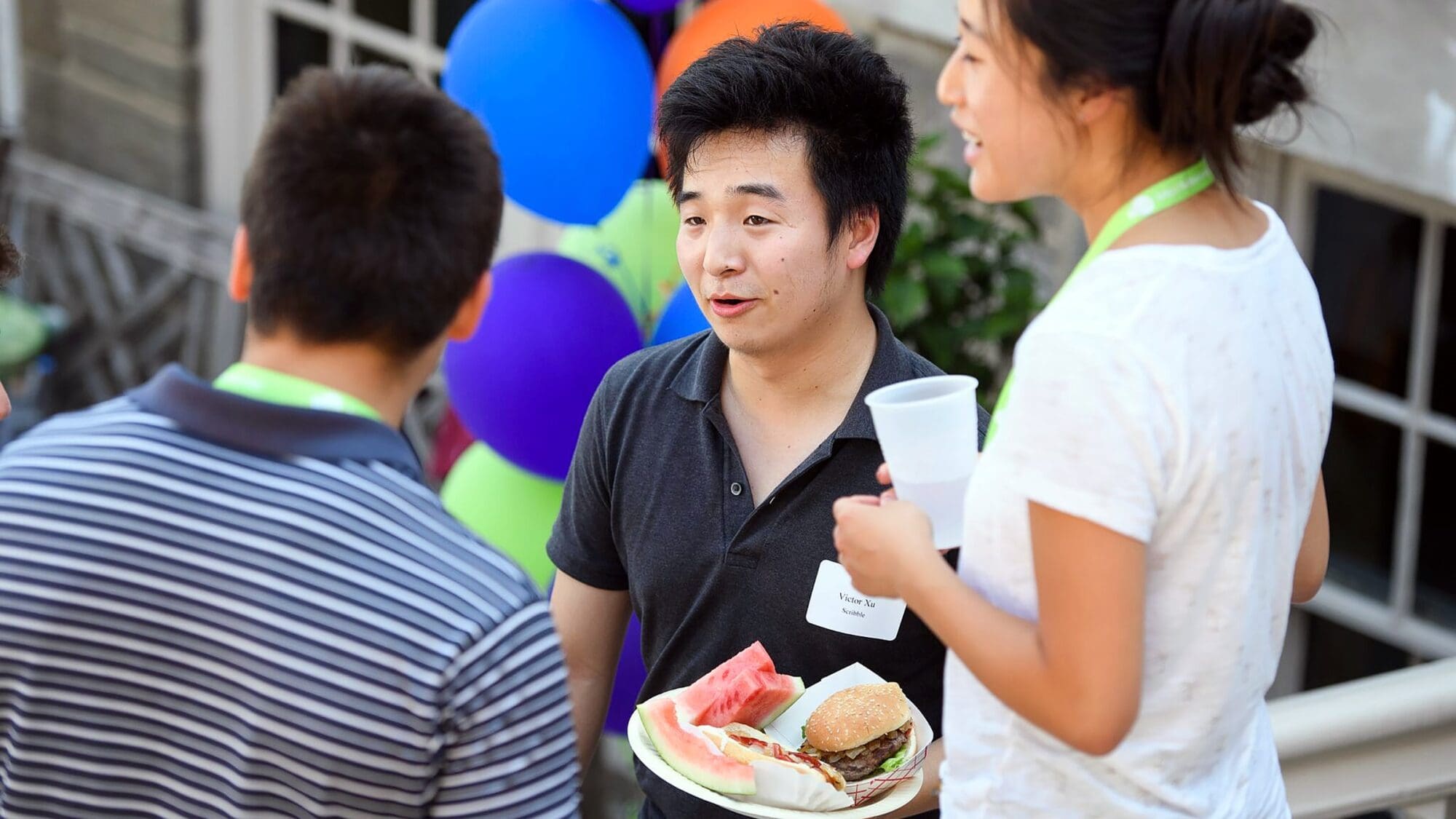 Students talk and eat at barbecue picnic