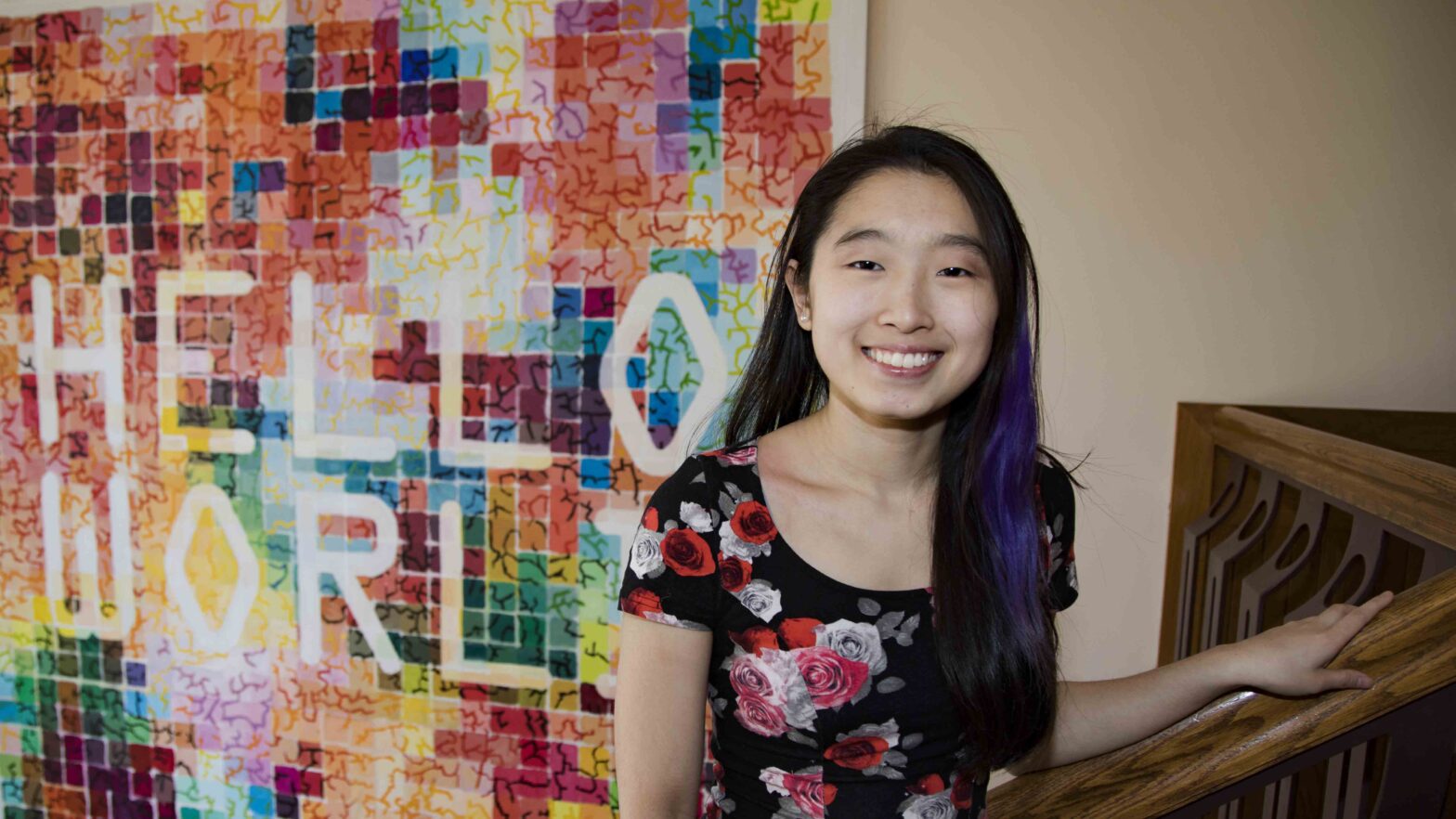Portrait of Katherine Lim in front of "Hello World" mosaic