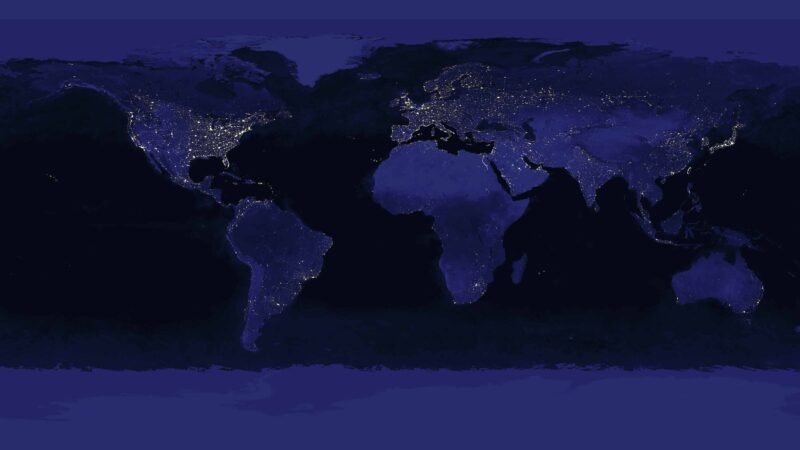 World map, nighttime, showing lights on to demonstrate energy use