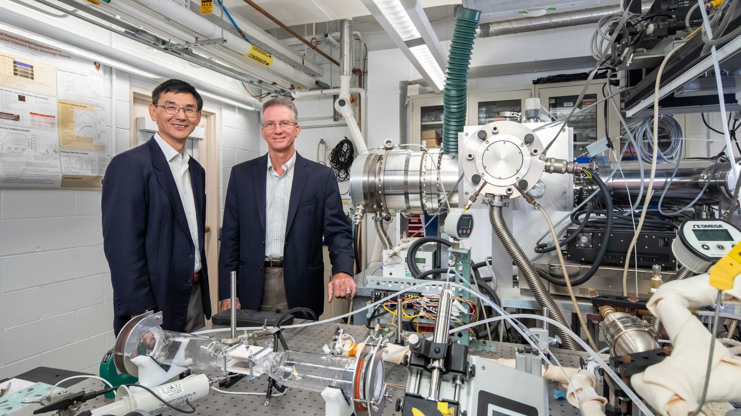 Two researchers in laboratory with molecular beam equipment