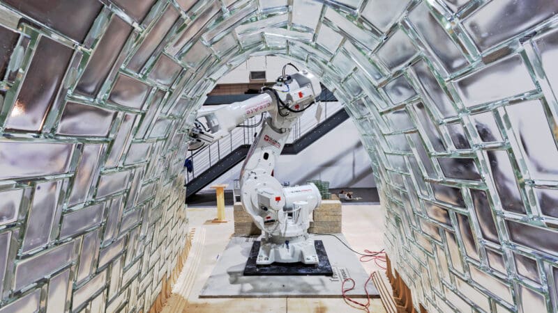 Robot show from within an arch made of glass blocks