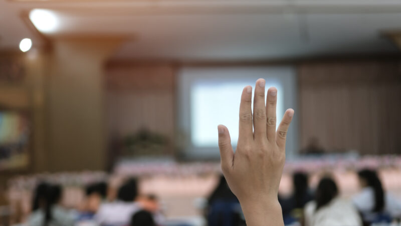 Raised hand in classroom