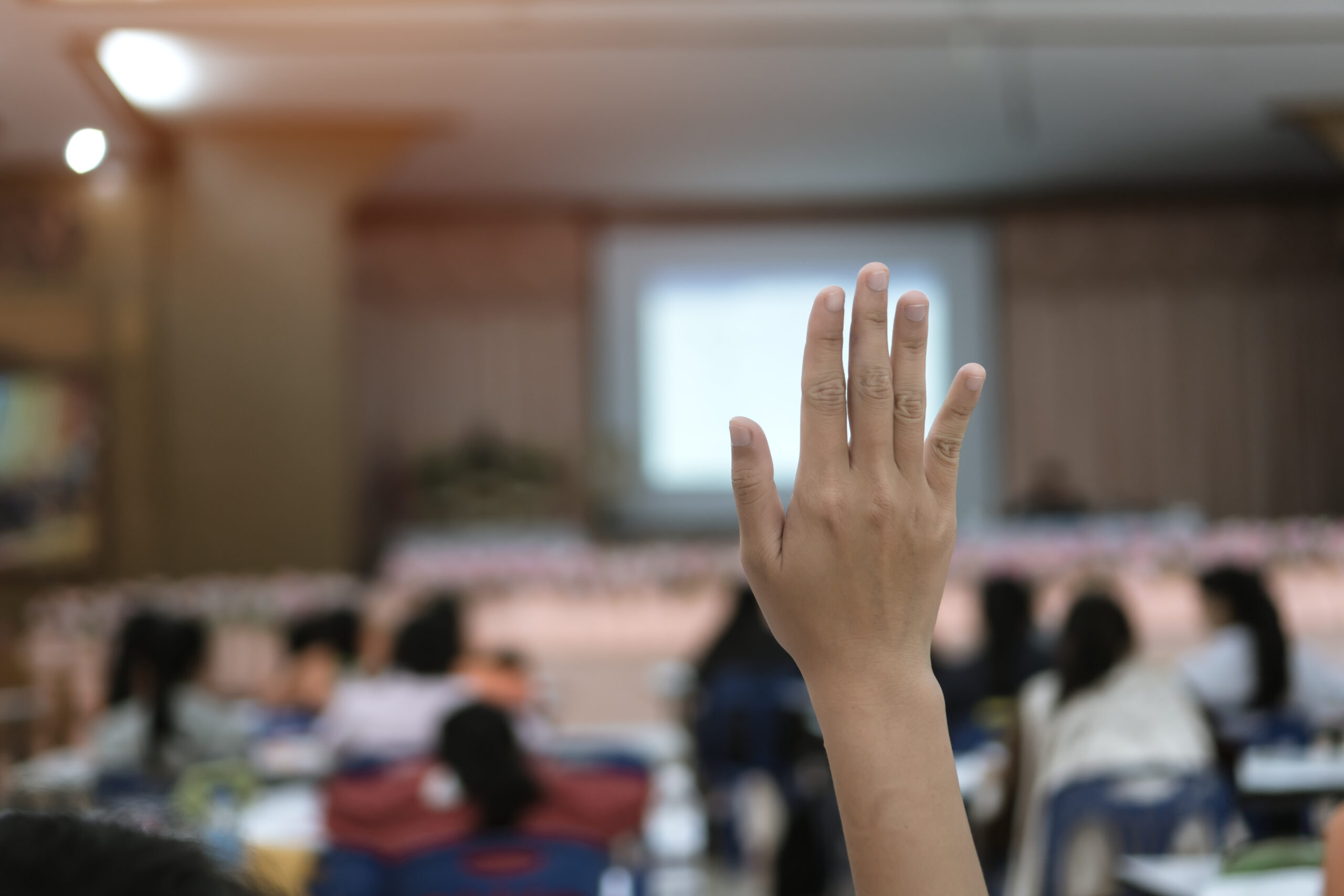 Raised hand in classroom