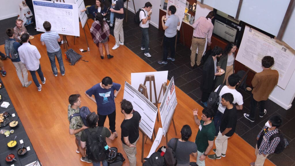 Students mingle at research poster session
