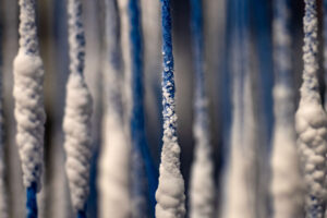 salt crystals on a network of vertical strings