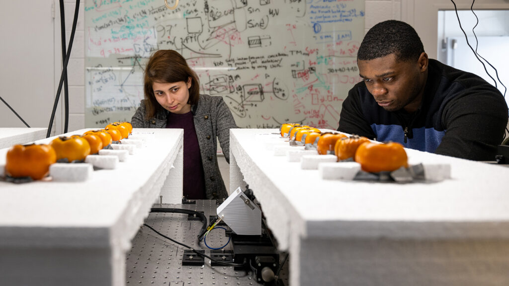 Professor and graduate student work together to tune sensing machinery in the lab.