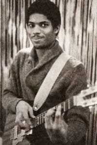 Stanley Jordan playing guitar and smiling.