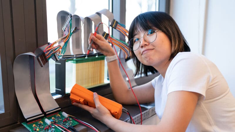Graduate student Kun Woo Cho working on hardware in a Princeton lab.