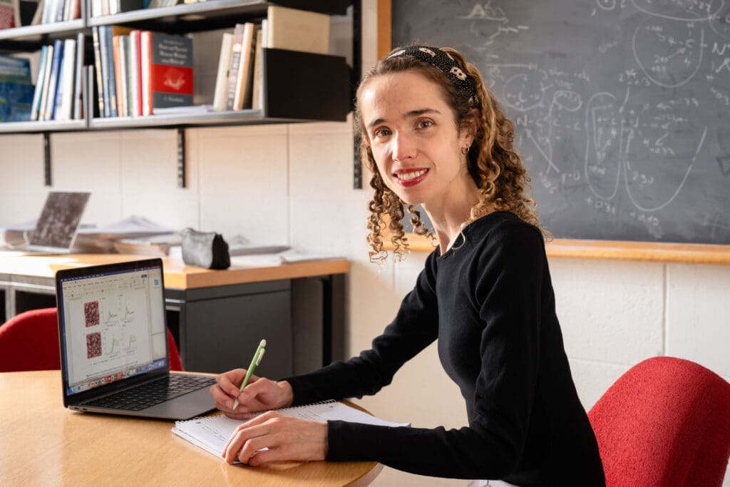 Portrait of Amélie Lemay in an academic office with a laptop computer.