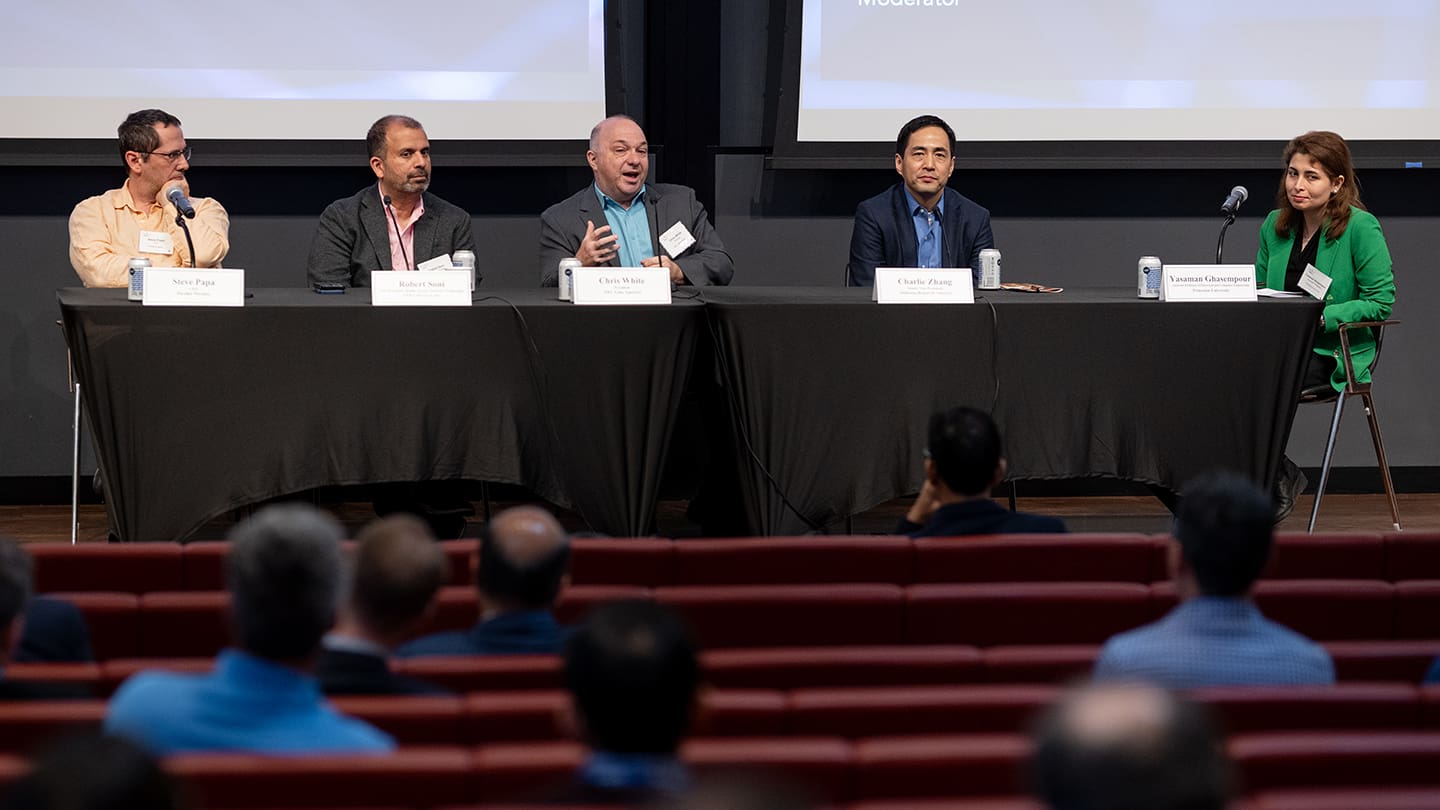 A panel of industry experts and an academic moderator discuss technology.