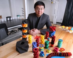Researcher sitting by a group of origami figures