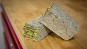 A cutaway image of brick with alternating layers of cement and green polymer