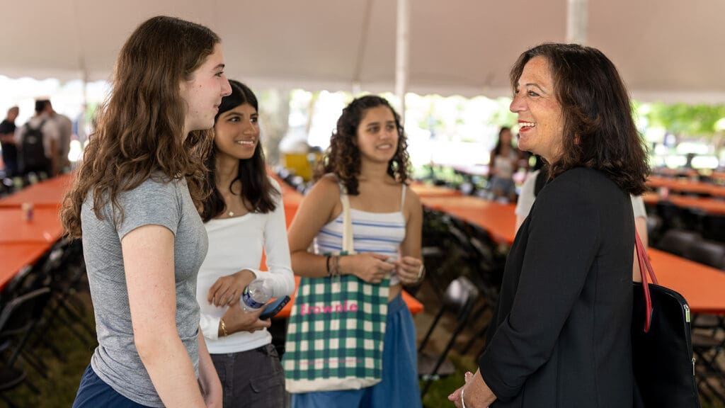 Four women speaking in a group