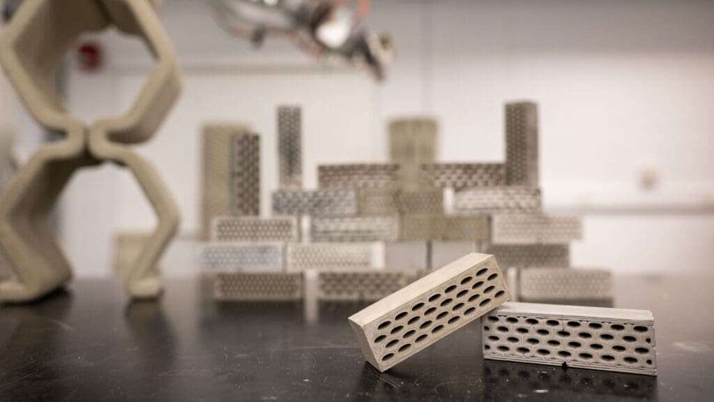 Bricks with hollow tubes through them sit on a lab table