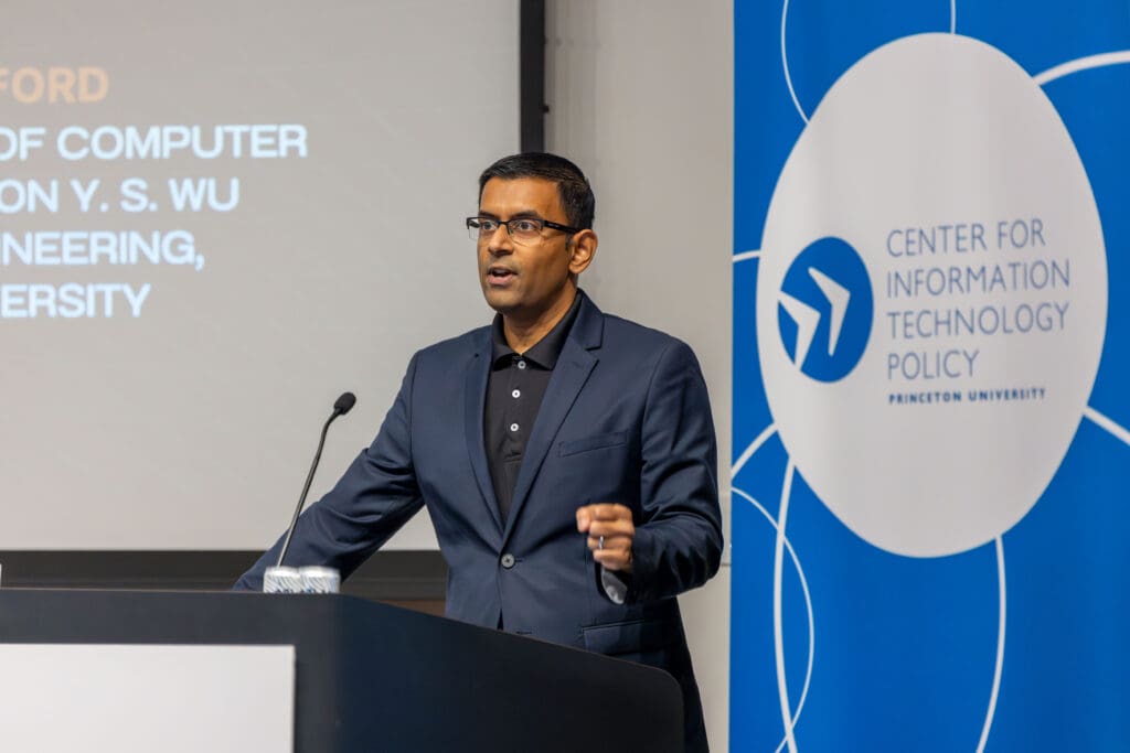 A man at a podium addressing an audience