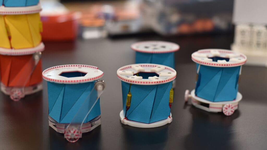 Blue paper cylinders on a black lab bench