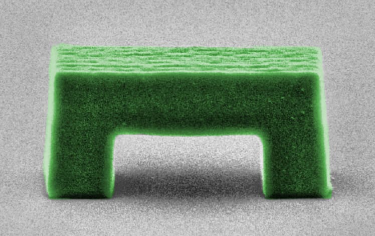 a single, microscopic, green-colored plastic arch
