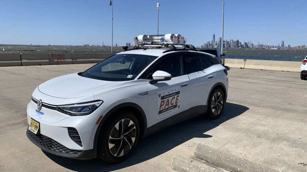 A white electric vehicle with a sensor array on the roof