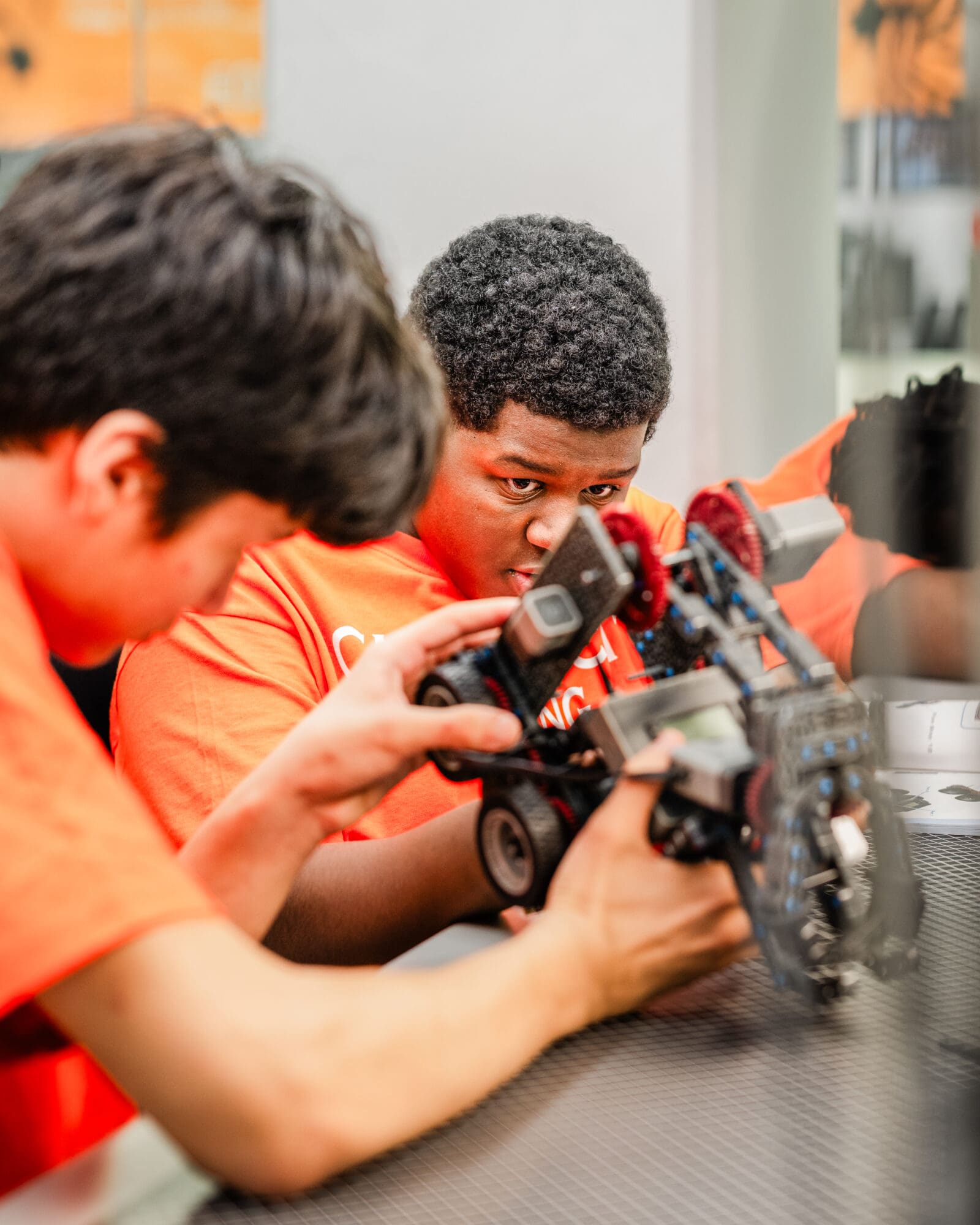Two students collaborating on building a robot