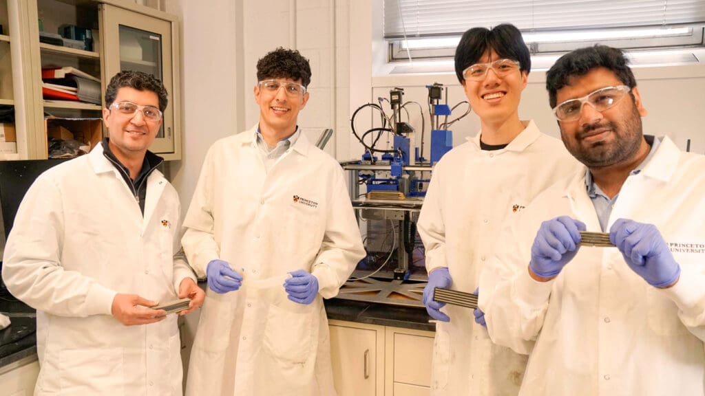 Four men in lab coats with samples of concrete