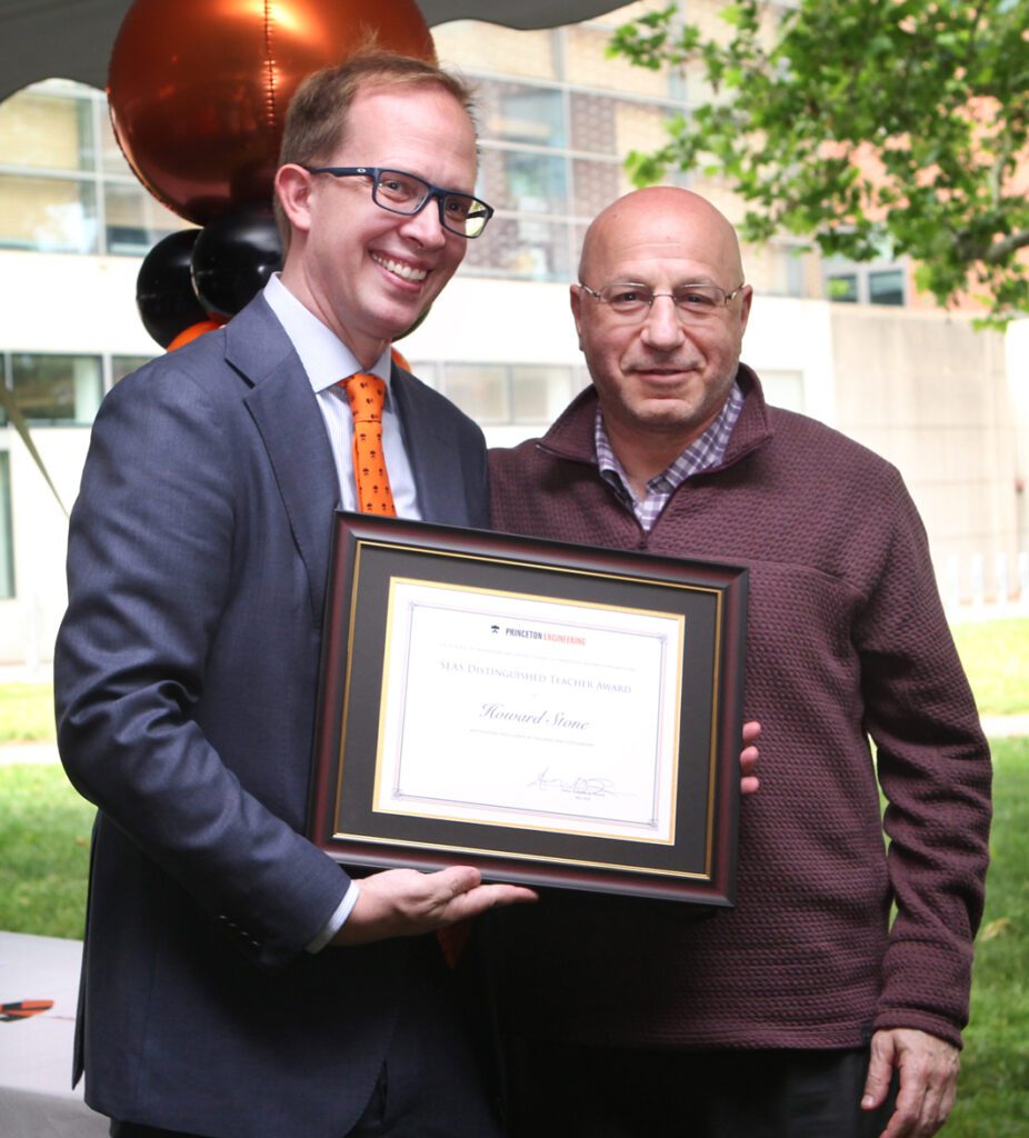 Two men with award citation