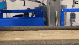 A 3D printer deposits a layer of concrete over polymer