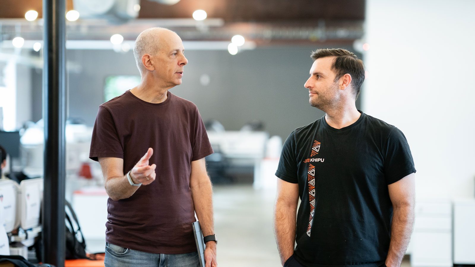 Guillermo Sapiro and Juan Matias Di Martino face each other, talking, in a large room.