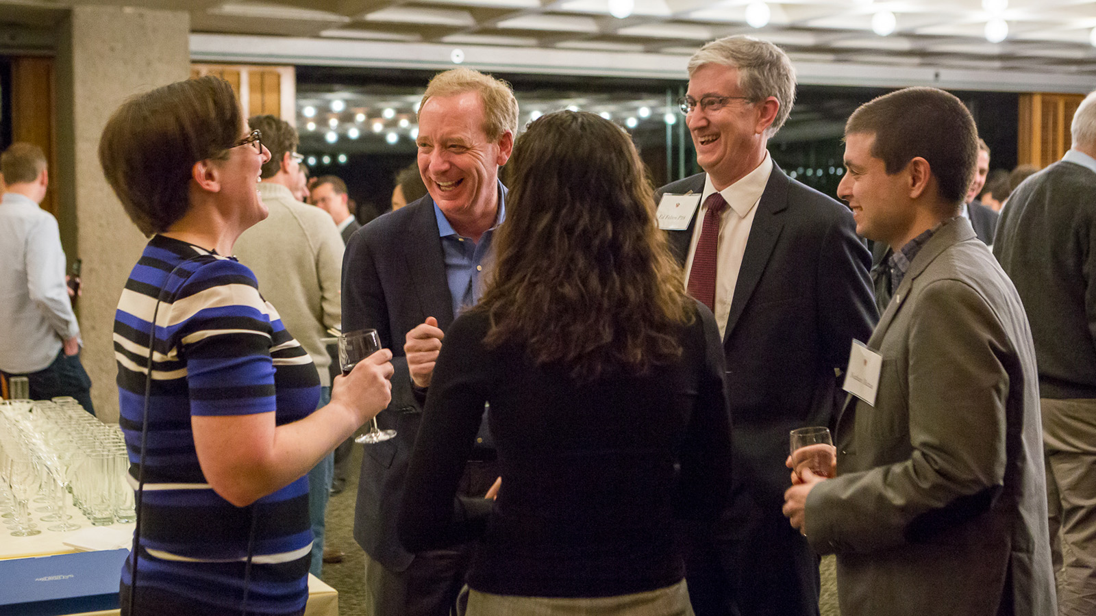 Microsoft President Brad Smith speaks with faculty member at reception