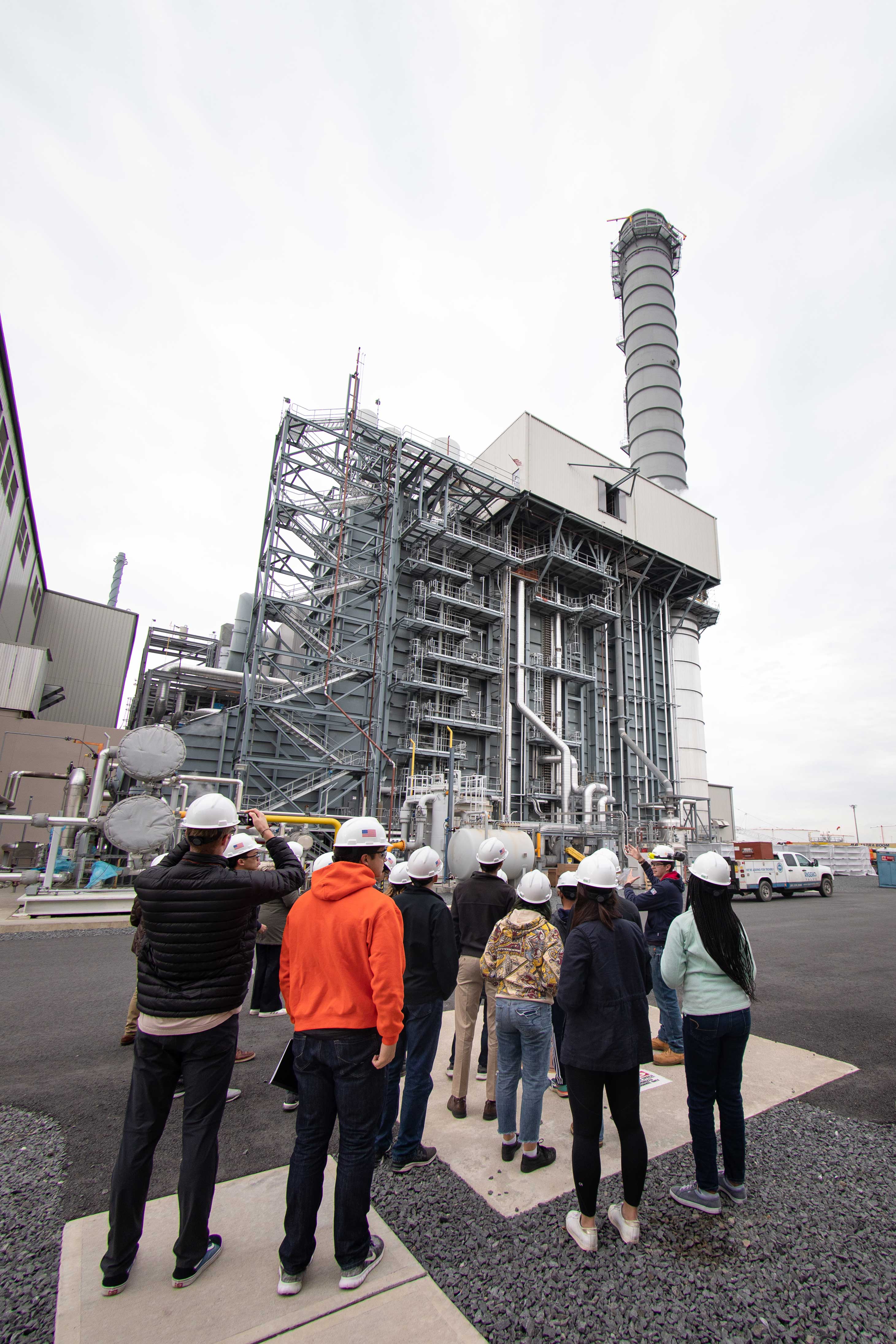 Students looking at large power plant structure