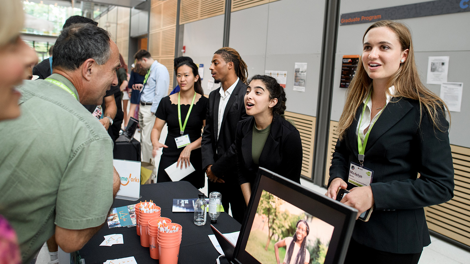 Student entrepreneurs speak with participants in Demo Day event