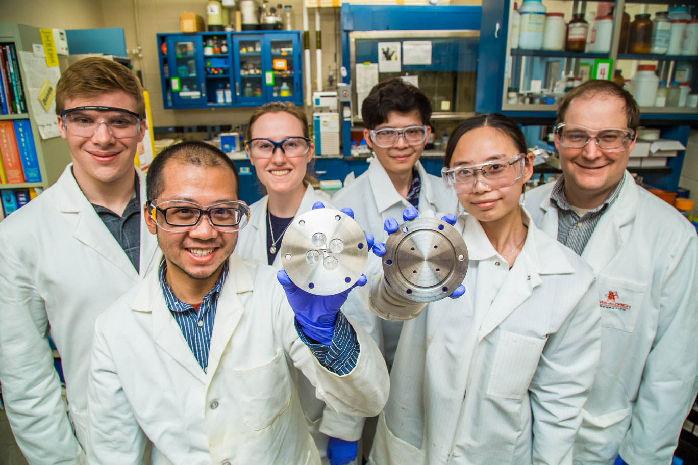  Researchers Prud'homme's lab display equipment used to encapsulate medicines for use in combating childhood diseases. From left, the team includes: Kurt Ristroph, Ph.D. student; Jack Lu, a 2017 graduate alumnus; Ellen Dobrijevic, a 2017 undergraduate alumna; and postdoctoral researchers Jie Feng, Joanna Zhang and Simon McManus.  Photo by David Kelly Crow