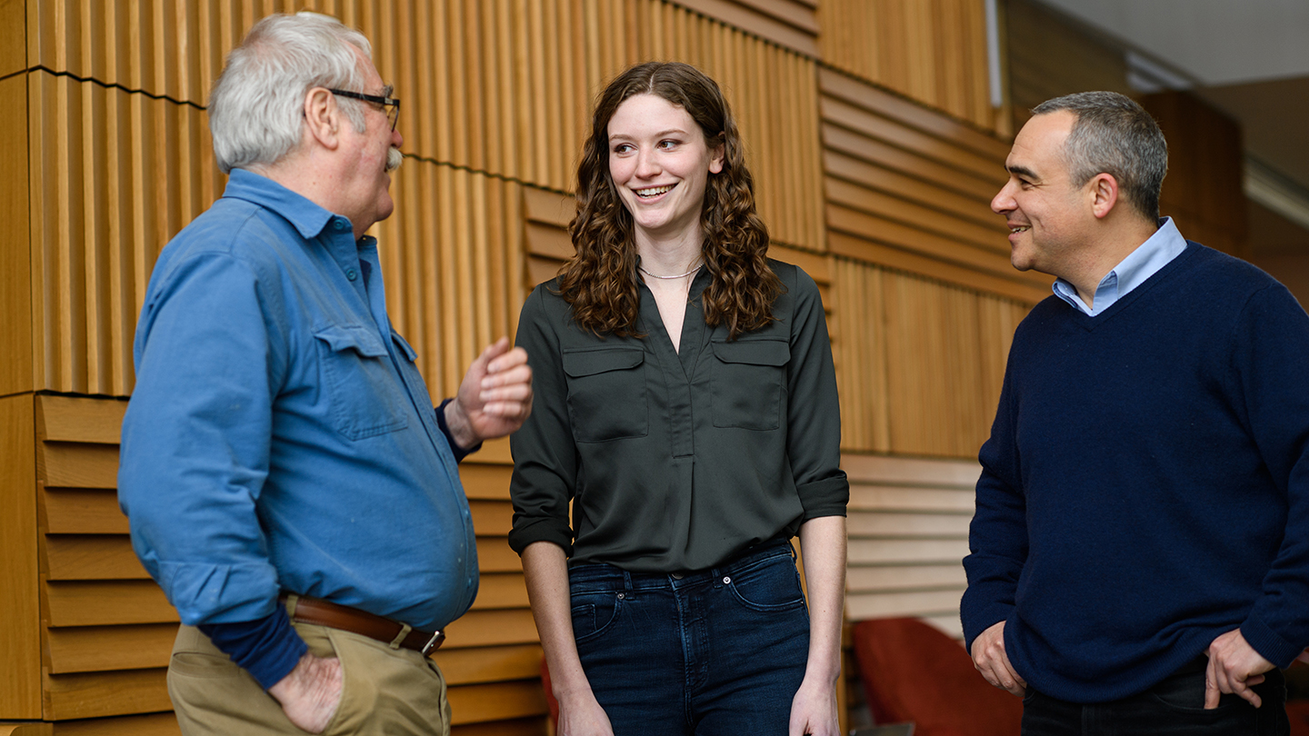 three researchers talking to one another