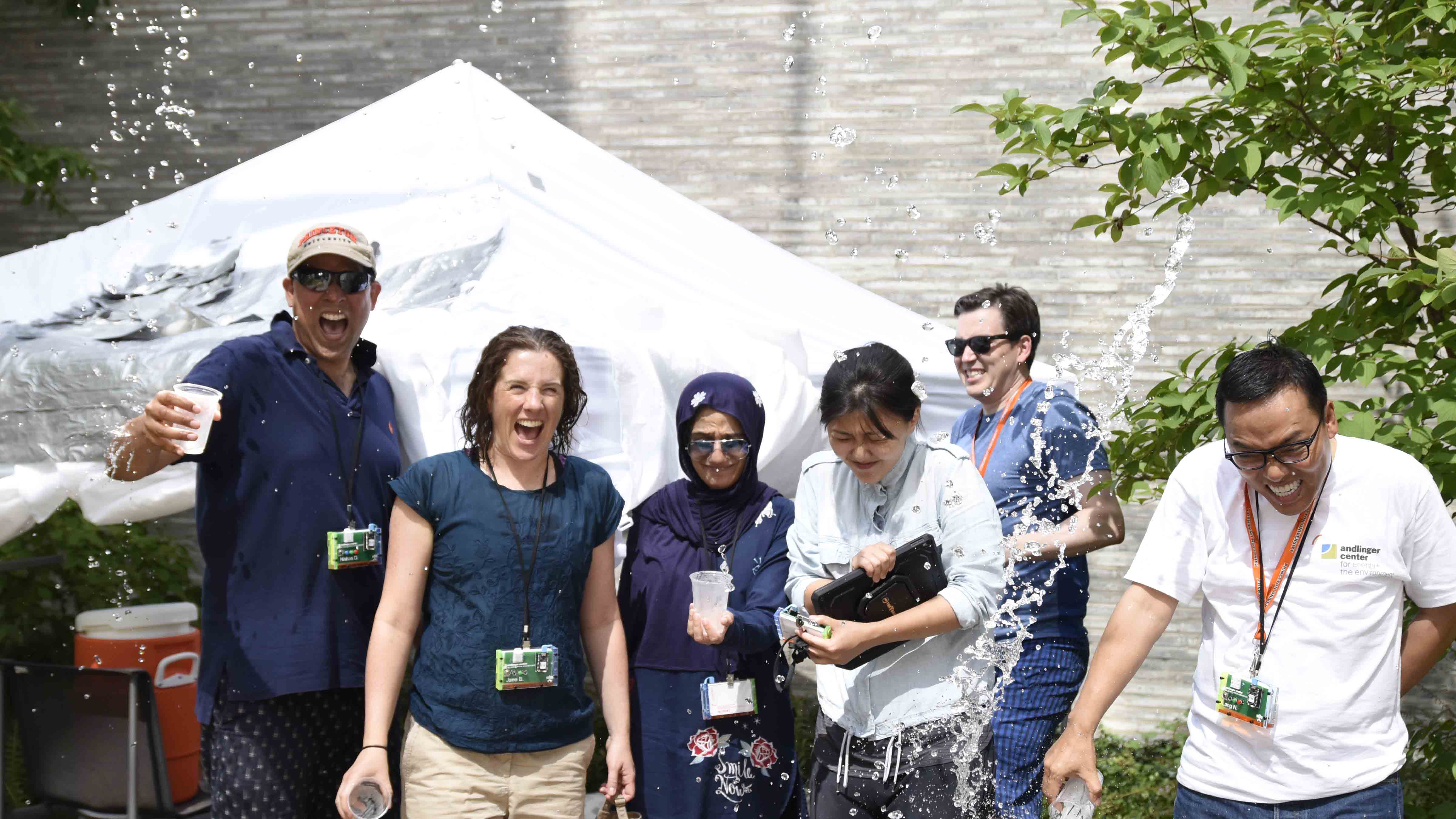 A team attending an executive education module on world energy challenges held at the Andlinger Center for Energy and the Environment in July cool off by pouring ice water over themselves. 