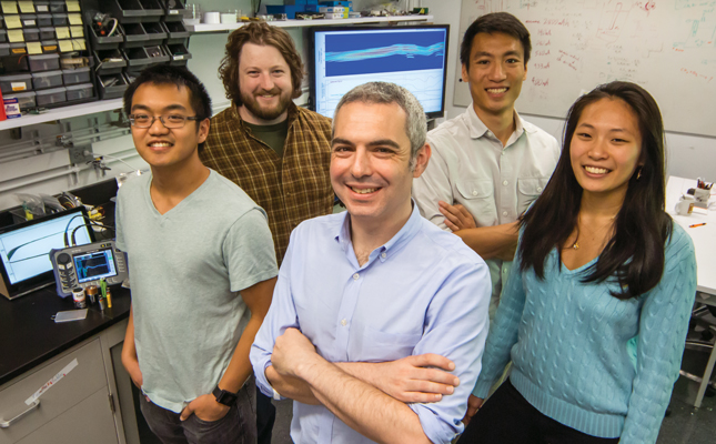 Daniel Steingart poses in the lab with his team